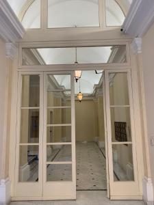 an empty room with a glass door in a building at Residenza Tritone Luxury Guest House Trevi Fountain in Rome