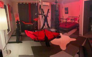 a room with a red room with a swing at Etoiles de Provence PASSION in La Ciotat