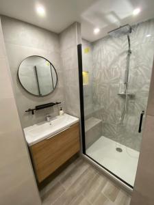 a bathroom with a shower and a sink and a mirror at Studio Disneyland Paris Holidays in Montévrain +20 photos