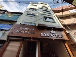 ティルチラーパッリにあるHotel Grand Stayの大社看板が貼られた高層ビル