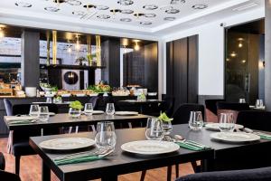 a restaurant with tables and chairs and a bar at Hotel Liberte 33 BW Premier Collection in Poznań +41 photos
