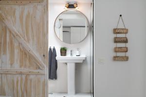 a bathroom with a sink and a mirror next to a door at Apartamento El Jable in Arrecife +27 photos