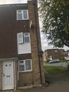 a brick house with a white door at The beautiful corner of Copenhagen close in Luton