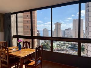 a dining room table with a view of the city at Apartamentos Gemelos 2 y 4 by Gestaltur in Benidorm