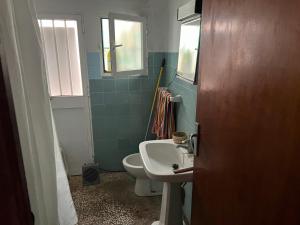 a small bathroom with a sink and a toilet at CHALET EN NERJA in Nerja