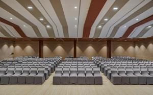 an empty lecture hall with rows of chairs at HOTEL ANS PRIDE Pudukkottai in Pudukkottai