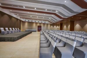 an empty lecture hall with white chairs and tables at HOTEL ANS PRIDE Pudukkottai in Pudukkottai
