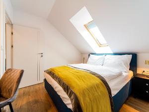 a bedroom with a bed with a yellow blanket on it at Apartament Dream View Aspen z Jacuzzi in Szklarska Poręba