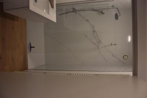 a shower with a glass door in a bathroom at villa alice in Koksijde