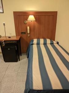 Postel nebo postele na pokoji v ubytování Pensión Coral