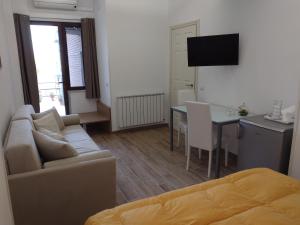 a living room with a couch and a table at B&B Villa Letizia in Castelbuono
