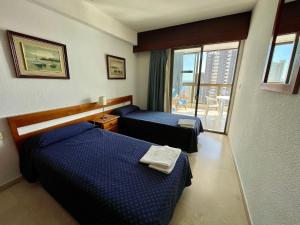 a hotel room with two beds and a balcony at Apartamentos Gemelos 2 y 4 by Gestaltur in Benidorm +86 photos