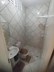 a bathroom with a shower and a toilet and a sink at Sua casa fora de casa in Fortaleza
