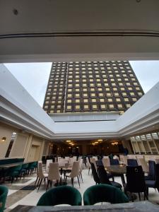 a large room with tables and chairs and a building at Astoria Grand Hotel in Sofia