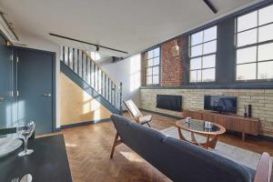 a large living room with a couch and a tv at No 5 at Simpson Street Apartments Sunderland in Sunderland