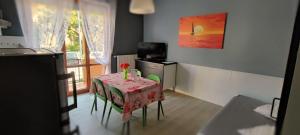 a kitchen with a table with a red tablecloth on it at Dianostellamarina in Diano Marina