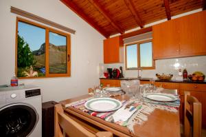 a kitchen with a table with two plates on it at Trouli Rokka House in Kissamos