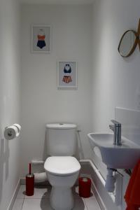 a bathroom with a toilet and a sink at Face à la mer - 50 m de la plage des homardiers in La Guérinière +20 photos