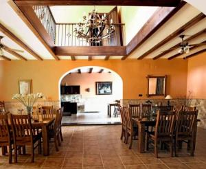 a large dining room with a table and chairs at HACIENDA LA HUERTEZUELA y CASA DEL LAGO in Villafranca de Córdoba