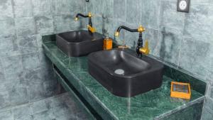 a bathroom with two sinks on a green counter at Villa avec piscine Asilah, terrain de foot privative in Asilah