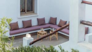 a purple couch sitting on the side of a building at Villa avec piscine Asilah, terrain de foot privative in Asilah