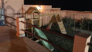 a childrens playground with a slide and a play set at Villa avec piscine Asilah, terrain de foot privative in Asilah