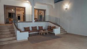 a living room with a couch and a table at Villa avec piscine Asilah, terrain de foot privative in Asilah