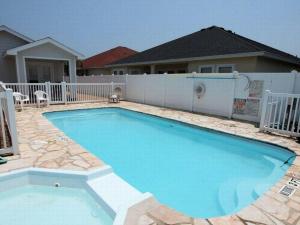a swimming pool in the backyard of a house at SFH201 Newly Renovated Ground Floor Townhome, Shared Pool, Near Beach in Port Aransas