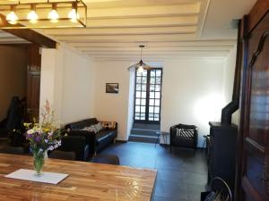 a living room with a table and a couch at Grand gîte au coeur d'un charmant village in Miglos