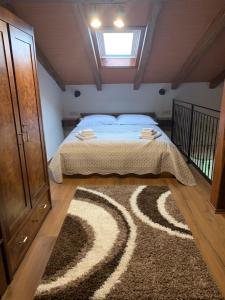 a bedroom with a bed and a rug on the floor at Holiday Home Mattiuzi in Nedeščina