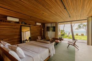 a bedroom with a large bed and a view of the ocean at Carmel Taíba Exclusive Resort in Taíba