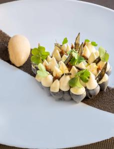 une assiette de nourriture avec des champignons et des légumes sur elle dans l'établissement Château De Pray, à Amboise