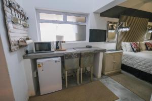 a small kitchen with a sink and a microwave at Rose Acres Guest House in Parys