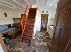 a staircase in a room with a couch and a television at Domek blisko granicy u Darka in Kunowice