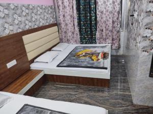 a small room with two beds in it at Vidya Guest House in Katra