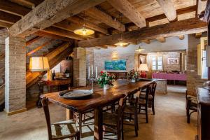 uma grande sala de jantar com uma grande mesa de madeira e cadeiras em Casa Gioia em Brigolo