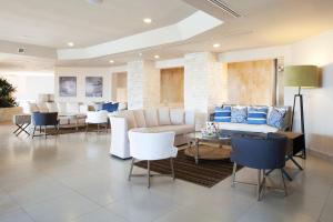 a lobby with couches and tables and chairs at Emporio Cancun - Buy All Inclusive Option in Cancún