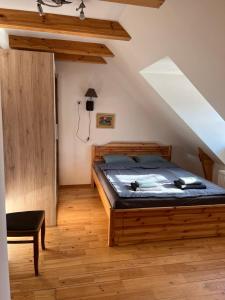 a bedroom with a wooden bed in a attic at Rumbas in Kuldīga