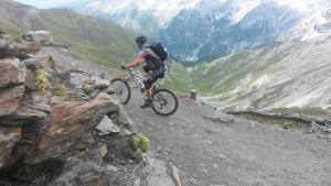 a man riding a bike on top of a mountain at Rifugio Garibaldi in Passo Stelvio