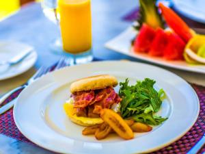 a sandwich and french fries on a plate on a table at Trident Hotel in Port Antonio