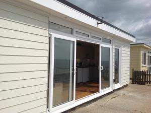 a large sliding glass door on a house at PORTHOLES in Ventnor