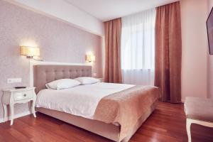 Postel nebo postele na pokoji v ubytování MyContinental Sibiu