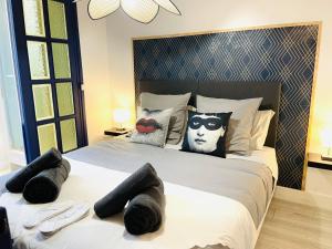 a bedroom with a large bed with a batman pillow at La Suite Beauvaisienne, T2 hyper centre in Beauvais