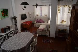 a living room with a table and a couch at El Regocijo in Oliva de la Frontera