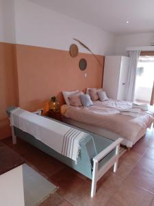 a bedroom with two beds and a glass table at Blue Peter Apartments in Protaras