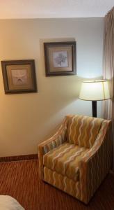a living room with a chair and a lamp at Landmark Resort in Myrtle Beach