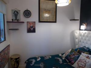 a bedroom with a bed and some pictures on the wall at Les deux moulins in Saint-Alban