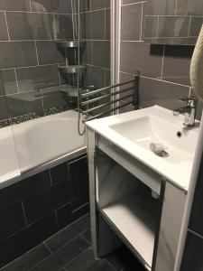a bathroom with a sink and a bath tub at Arcotel Cannes 4 minutes du Palais des Festivals - NEW MANAGEMENT NEW TEAM - OLD REVIEVV in Cannes
