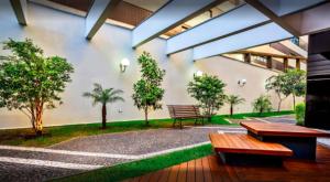 a courtyard with benches and trees in a building at Tudo próximo a você in Sao Paulo