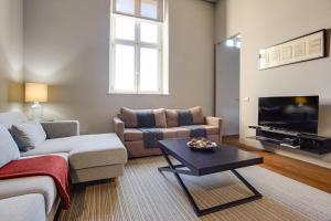 a living room with a couch and a table at 8 Building Serviced Apartment by the River in Lisbon